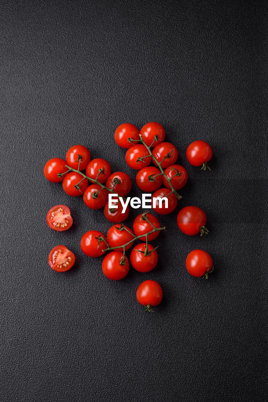 red, food and drink, food, fruit, healthy eating, studio shot, wellbeing, freshness, indoors, jewellery, no people, produce, still life, black background, gray, bead, large group of objects, high angle view, fashion accessory, plant, art, flower, tomato, gray background, directly above, copy space