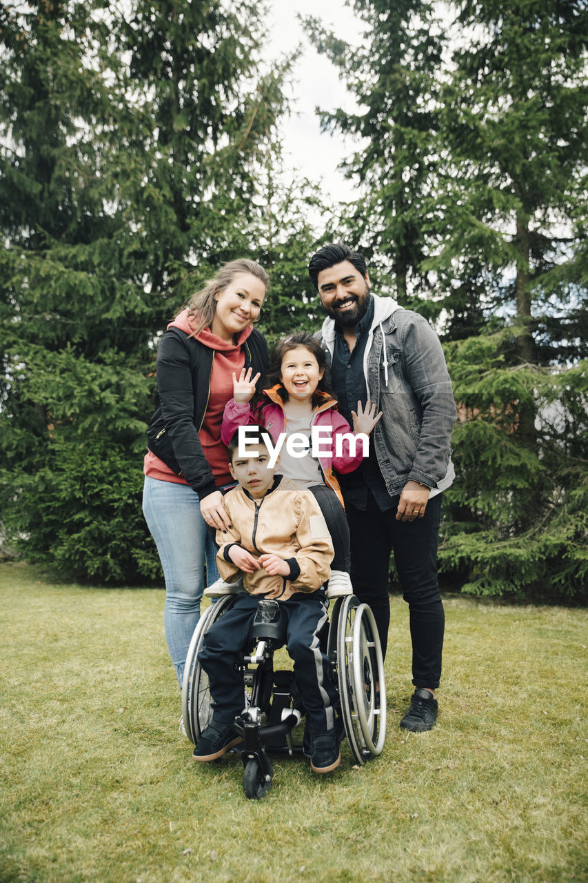 Portrait of happy parents with children enjoying at park