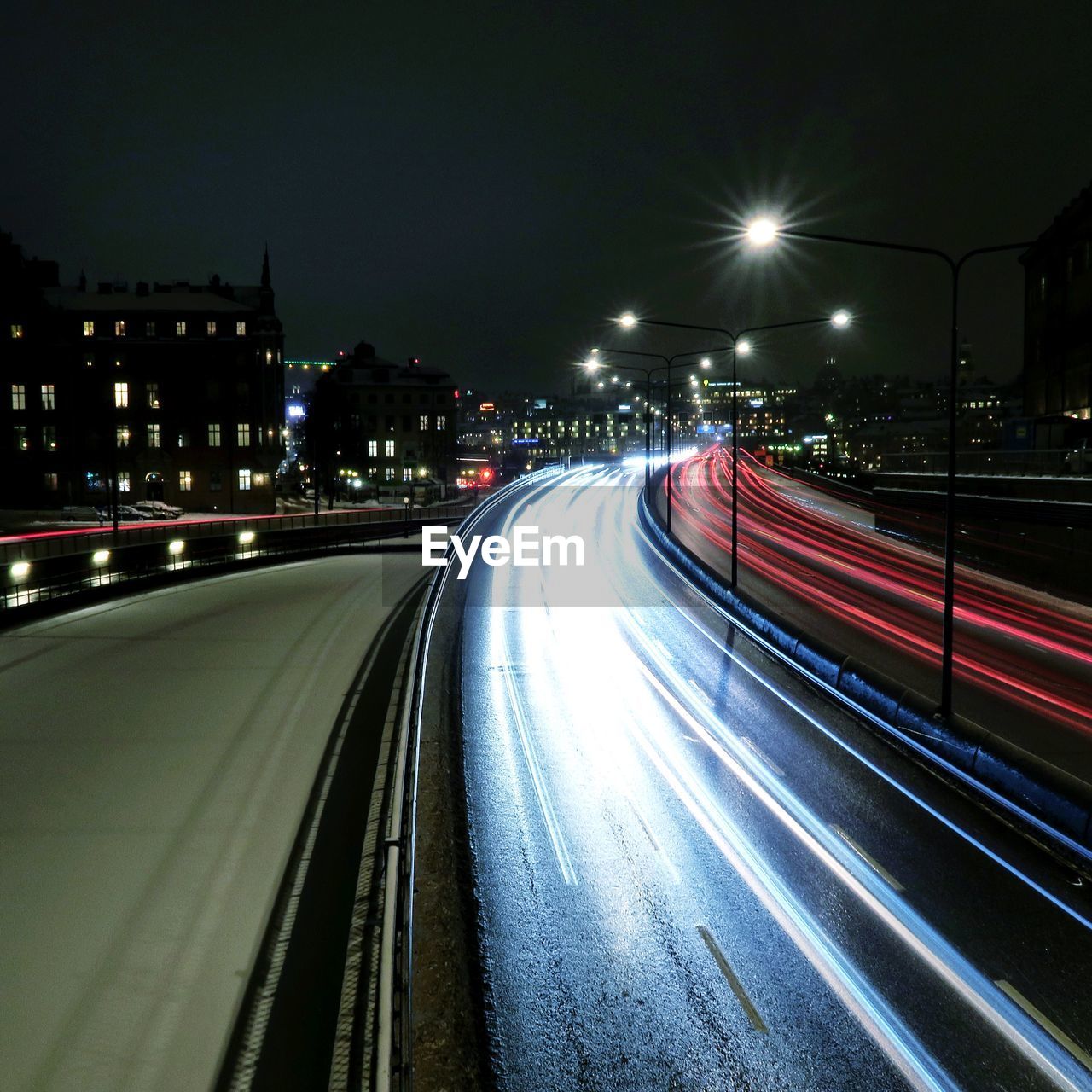 Light trails on road in city at night