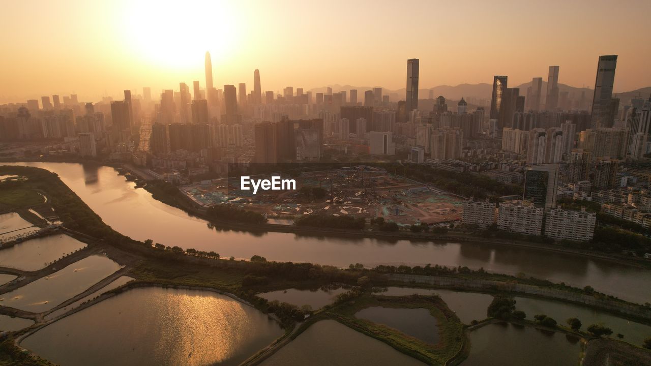 high angle view of illuminated cityscape at sunset