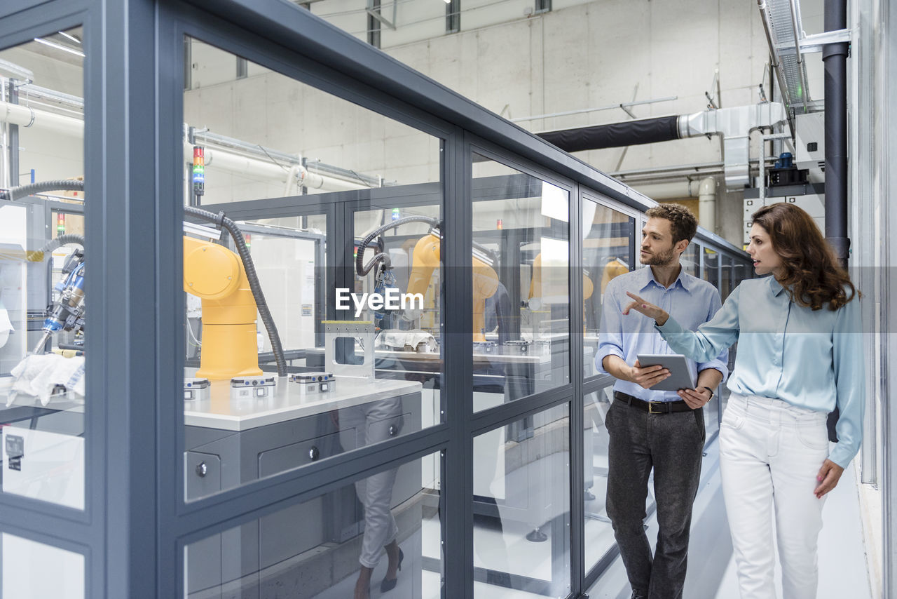 Businessman and woman having a meeting in high tech company