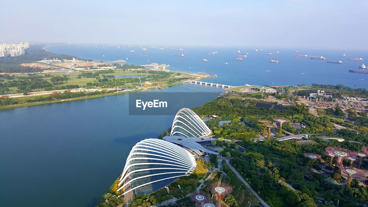 High angle view of buildings by sea against sky