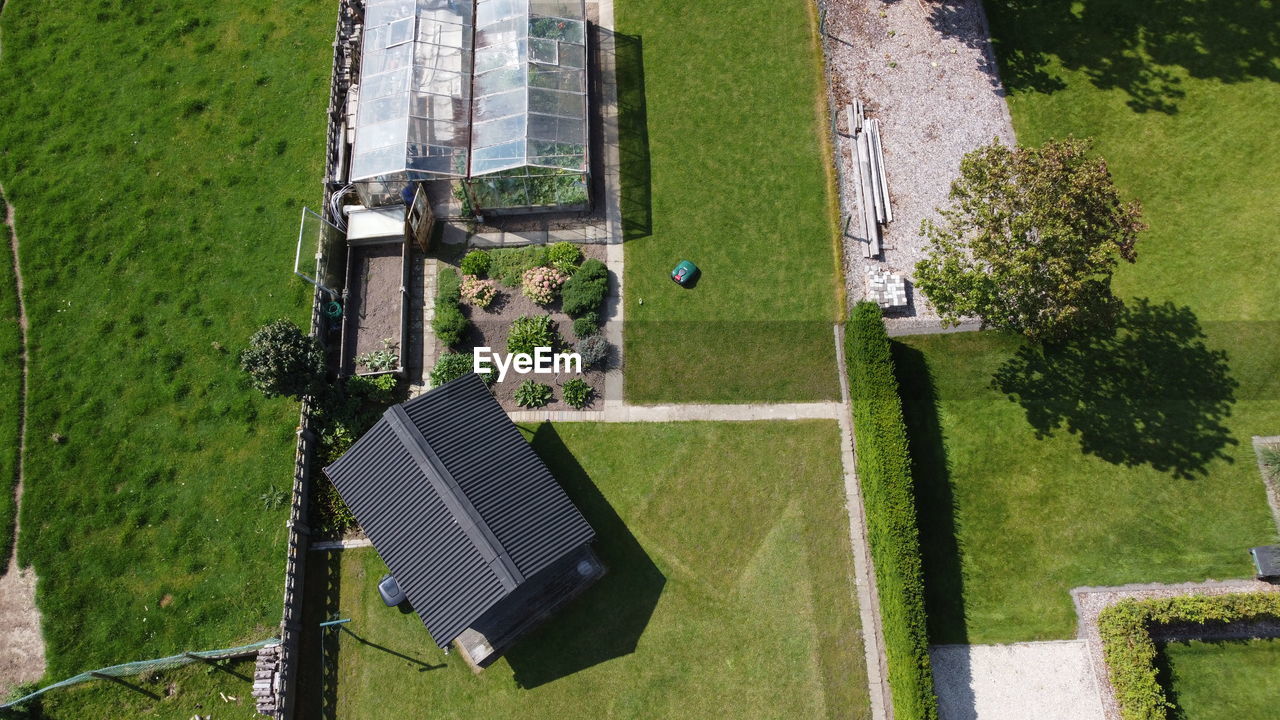 Aerial view of lawn by greenhouse