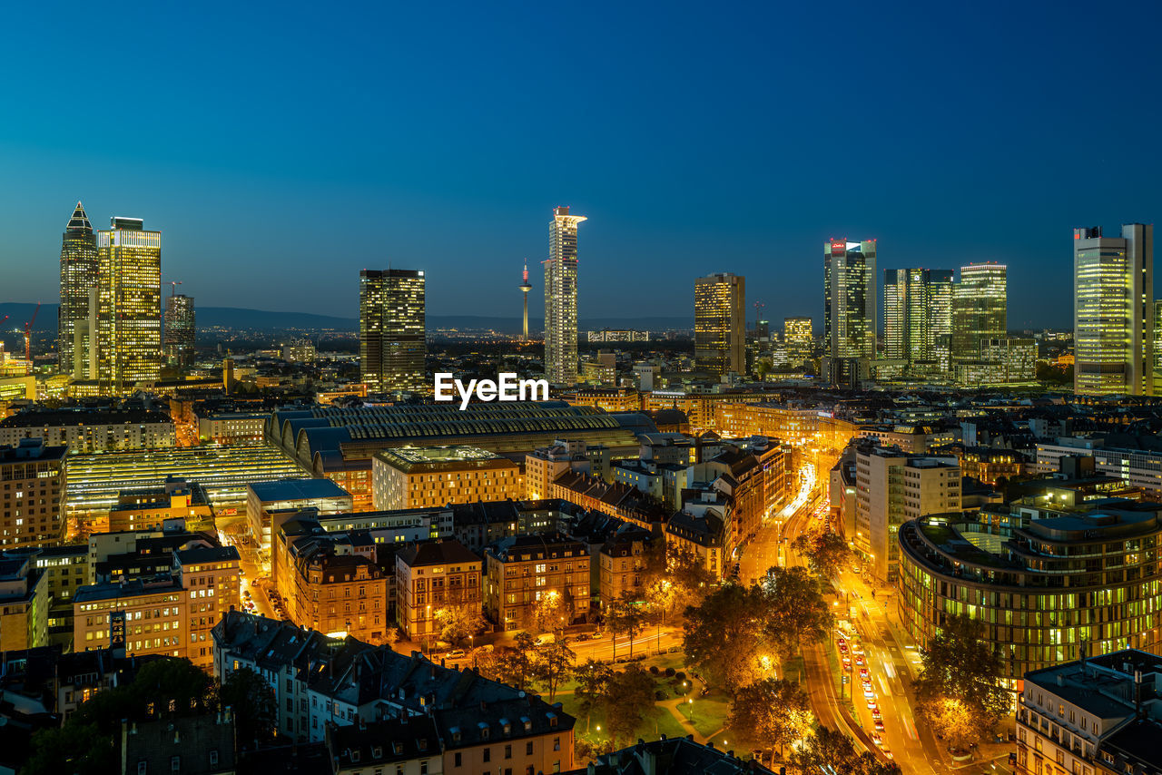 High angle view of illuminated buildings in city at dusk