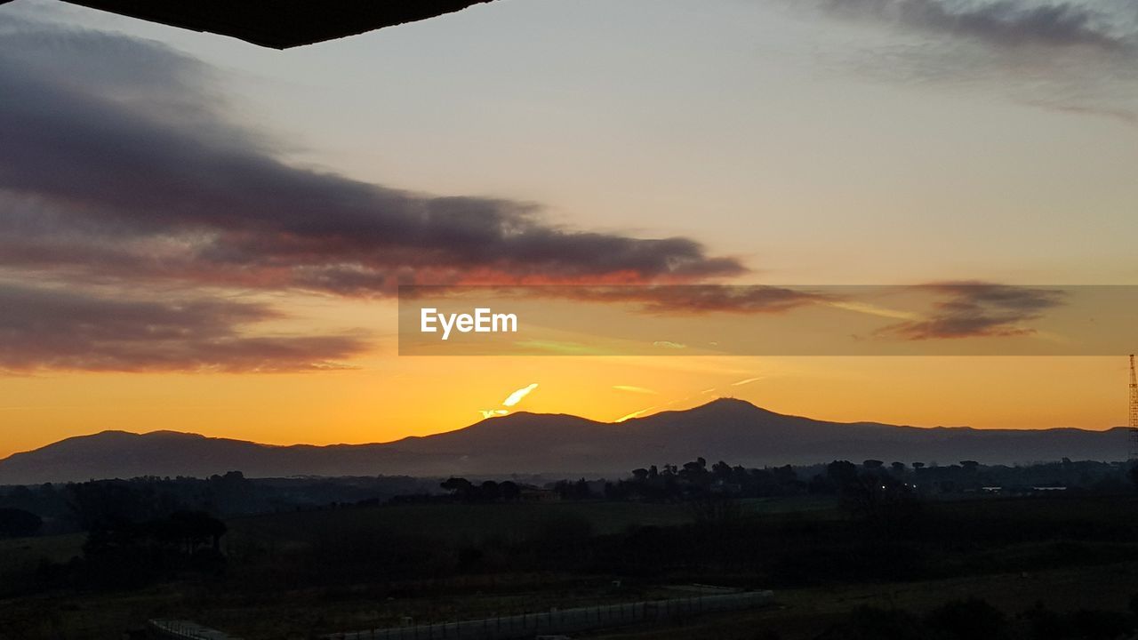 SCENIC VIEW OF SILHOUETTE LANDSCAPE AGAINST ORANGE SKY