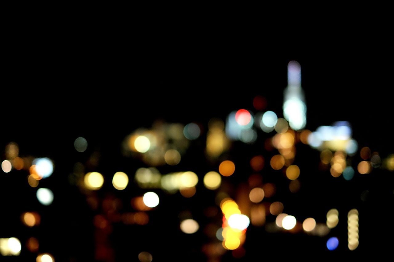 Blurred image of illuminated city at night