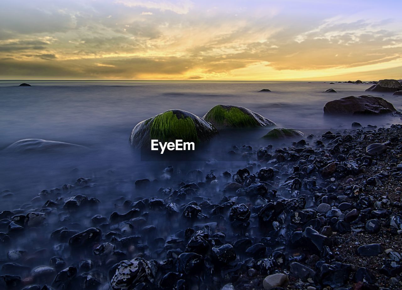 Scenic view of sea against sky at sunset