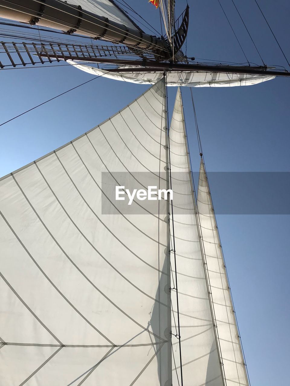 Low angle view of sailboat against clear sky