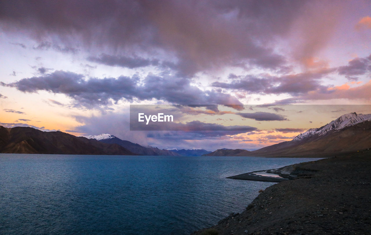 Scenic view of sea and mountains during sunset