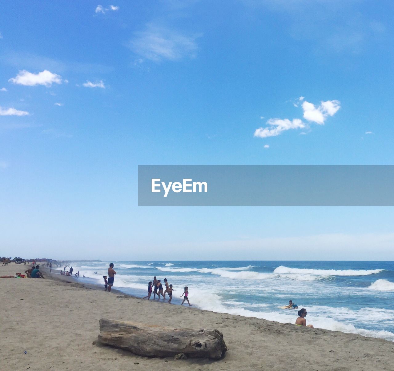 PEOPLE AT BEACH AGAINST SKY