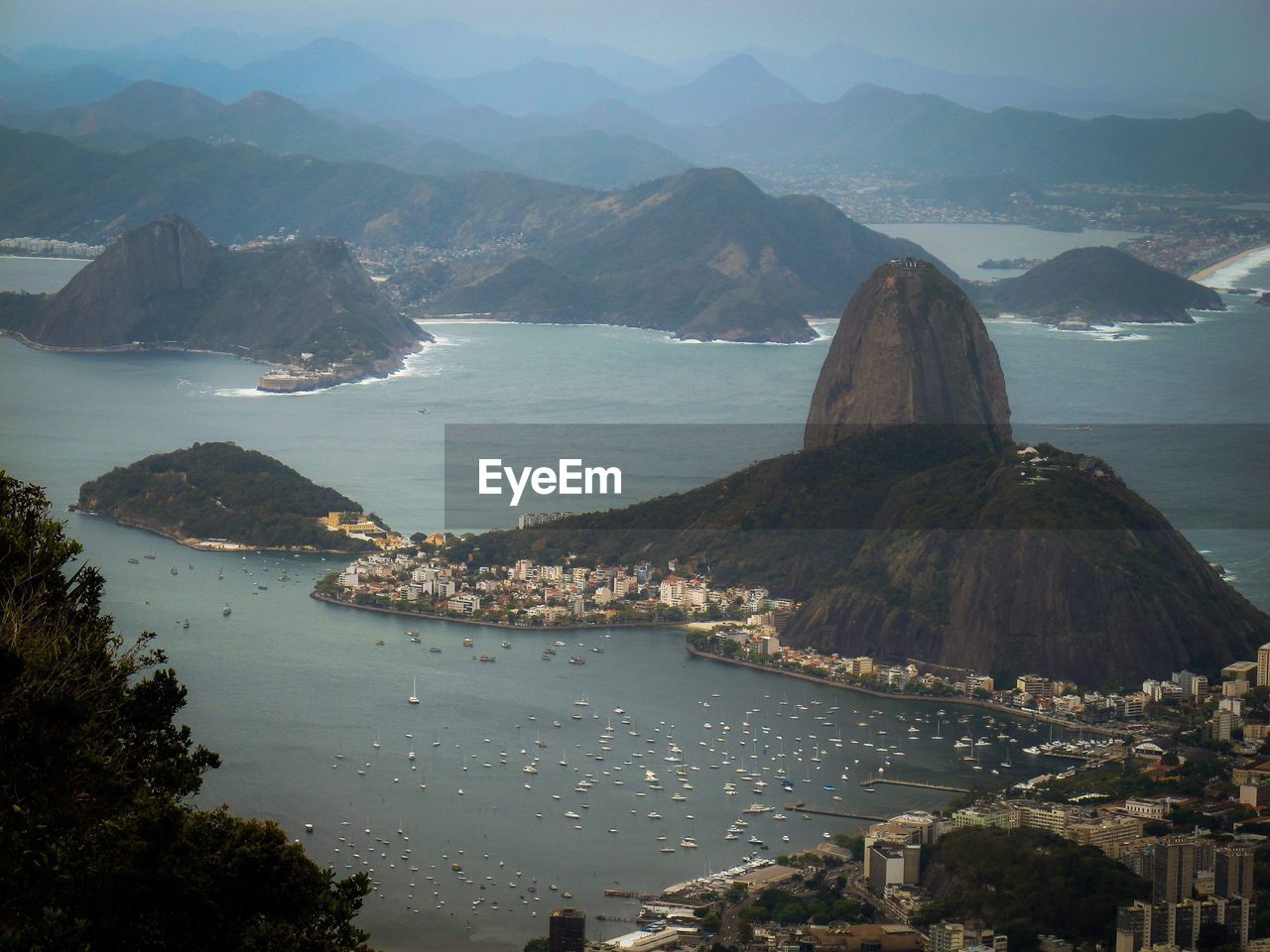 High angle view of sea and mountains against sky