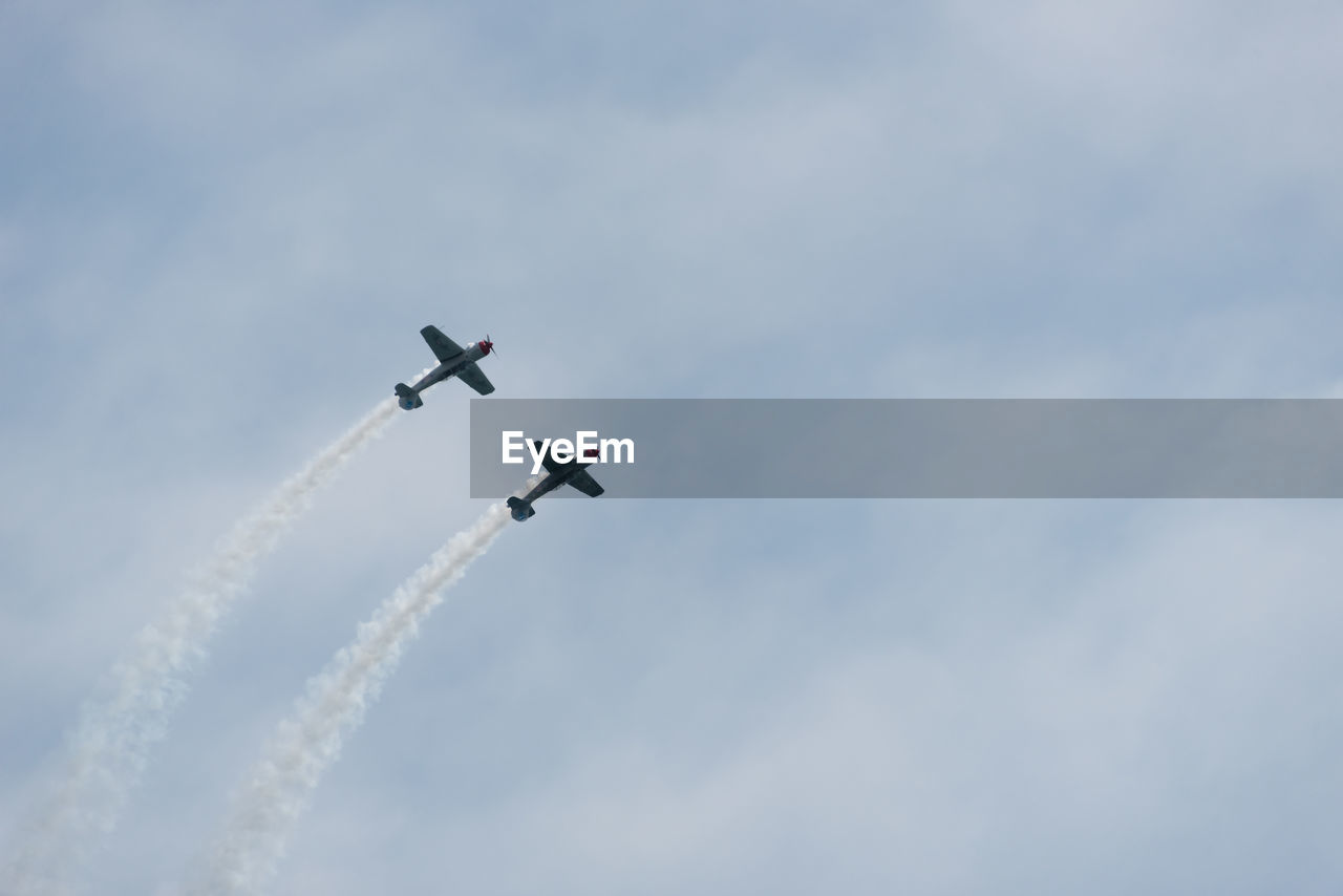 Low angle view of airshow against sky