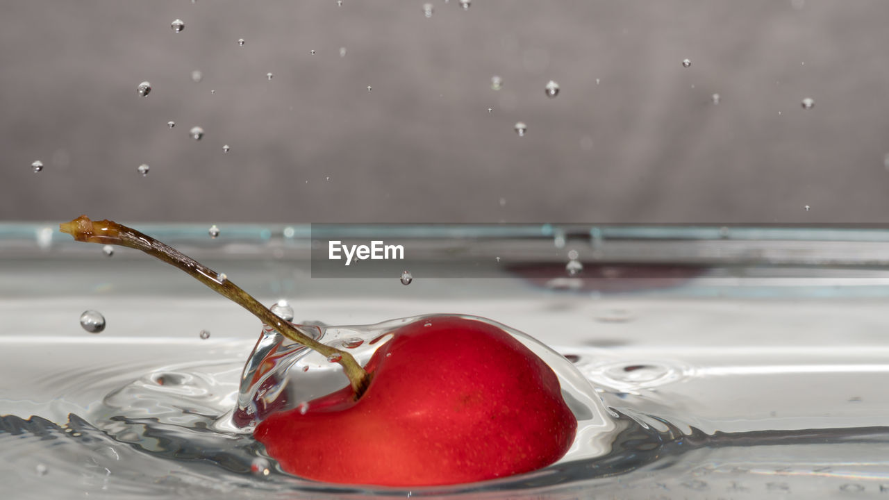 CLOSE-UP OF WATER SPLASHING IN GLASS