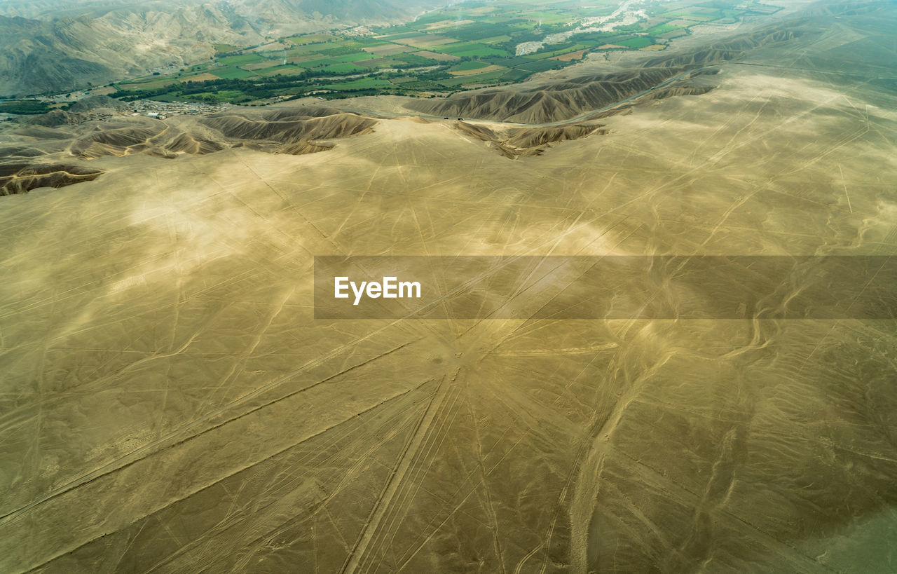 HIGH ANGLE VIEW OF SAND DUNE IN THE WATER