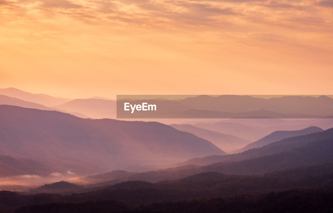 Scenic view of silhouette mountains against sky during sunset