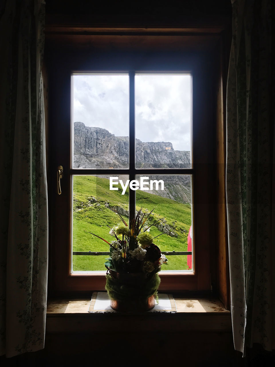 PLANTS SEEN THROUGH WINDOW OF HOUSE