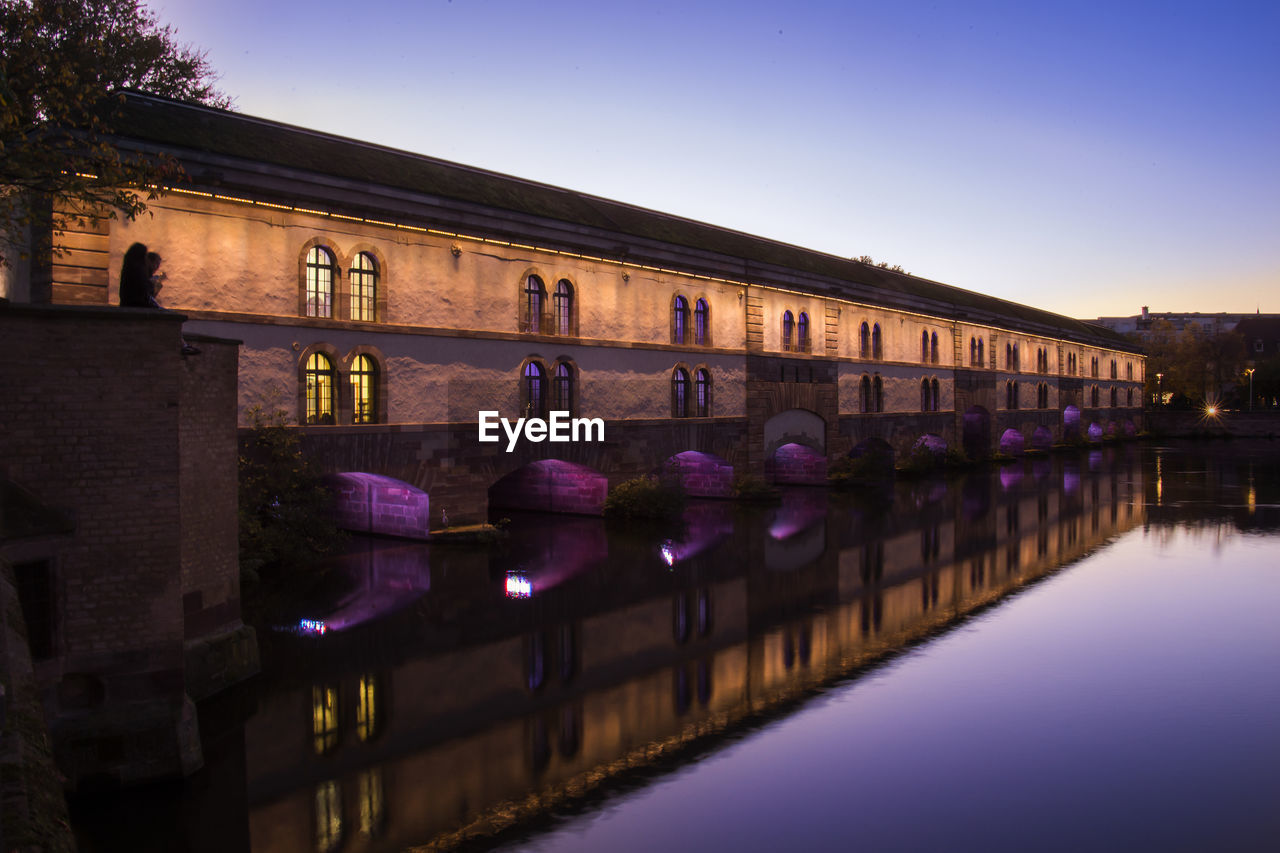 Reflection of building in water at night