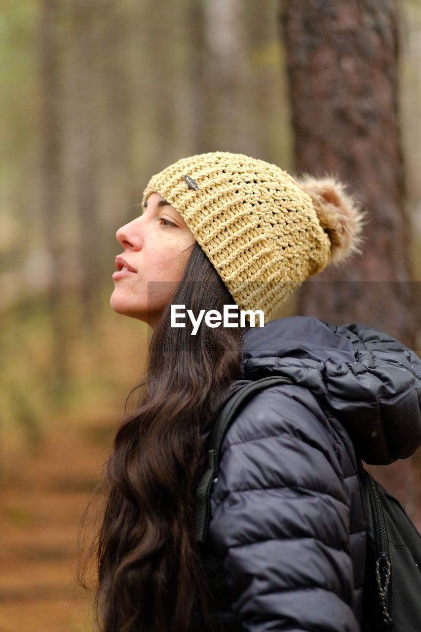 Rear view of woman wearing hat in woods