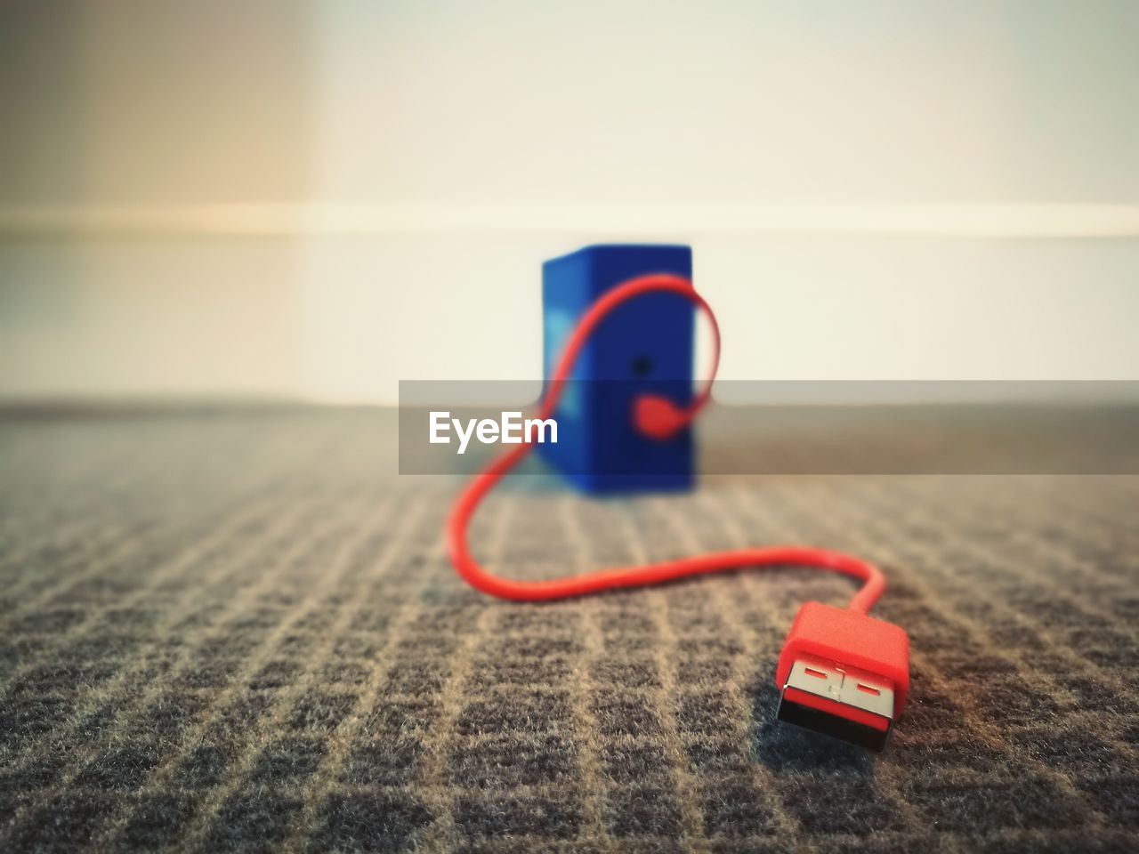 Close-up of usb cable on rug