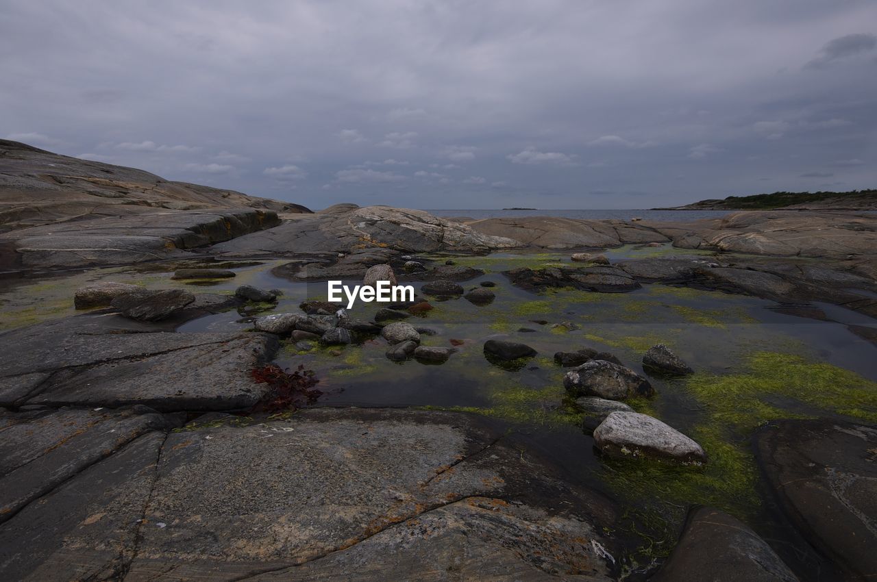 Rocks on shore against sky