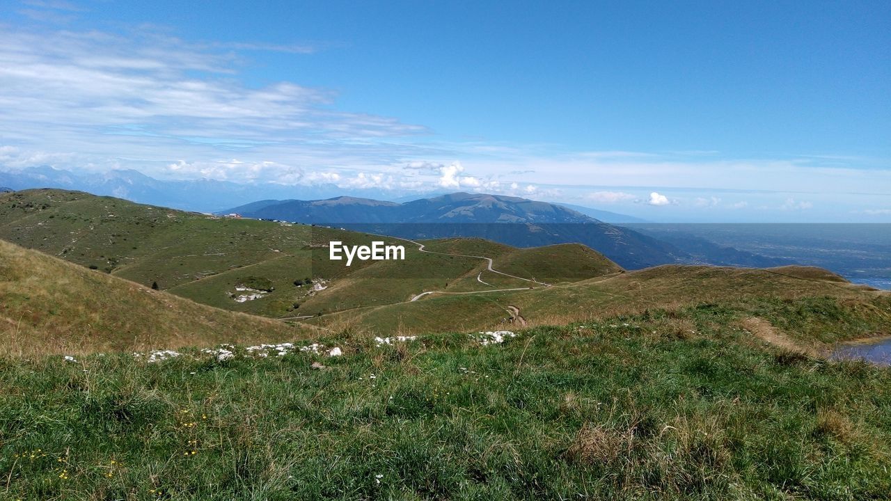 SCENIC VIEW OF GRASSY FIELD AGAINST SKY