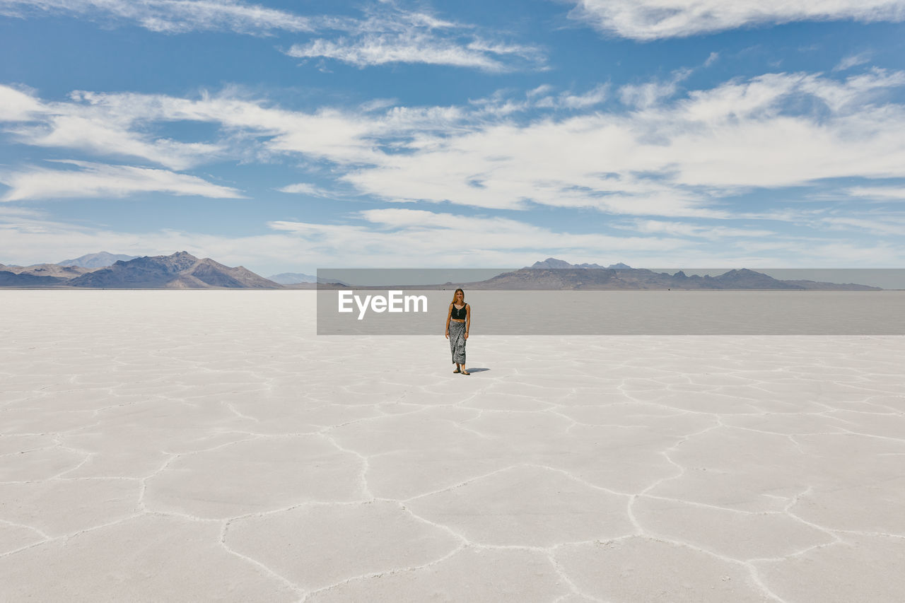 Young woman exploring bonneville salt flats during a summer road trip.