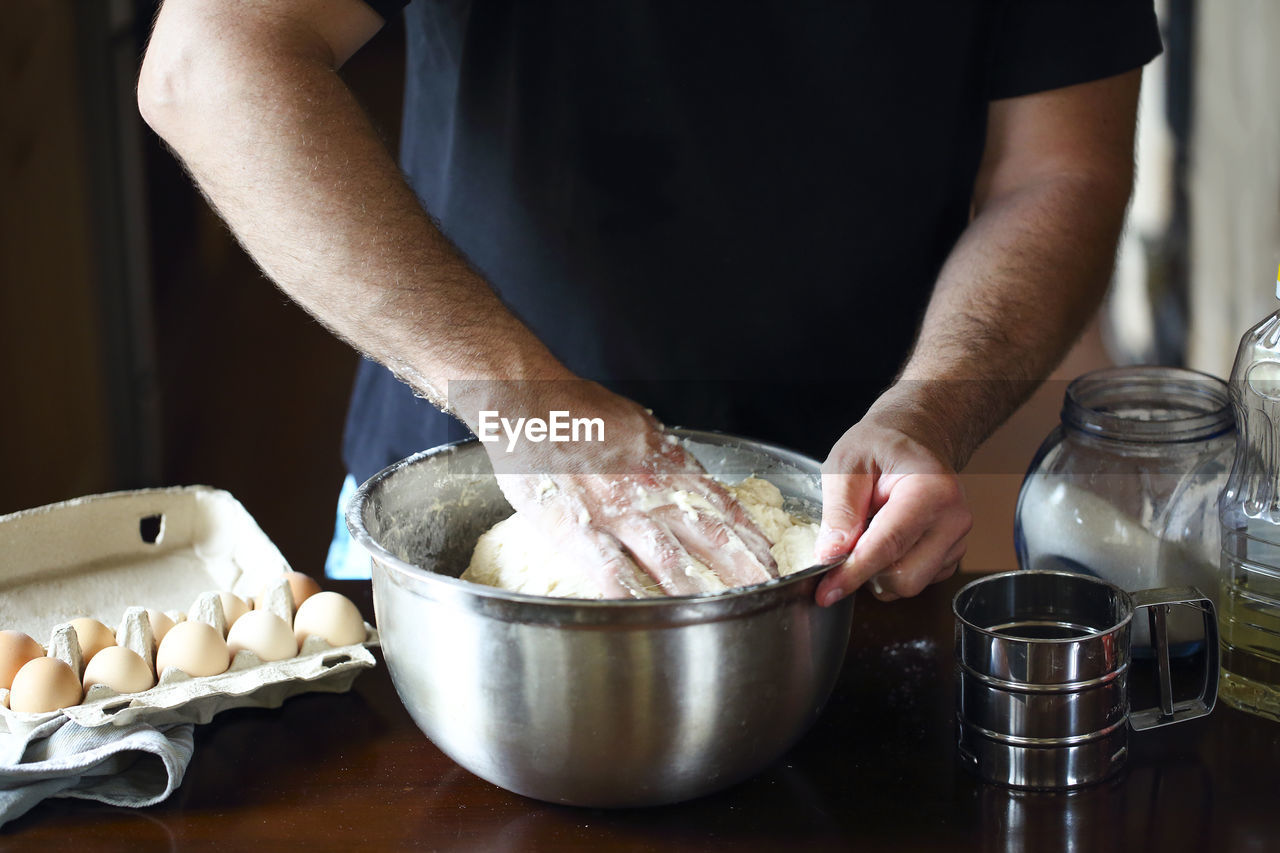 Midsection of man preparing food