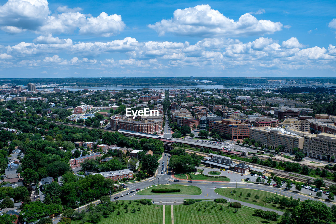 Aerial view of cityscape against cloudy sky