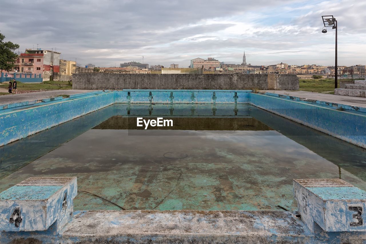 Abandoned swimming pool on sport field