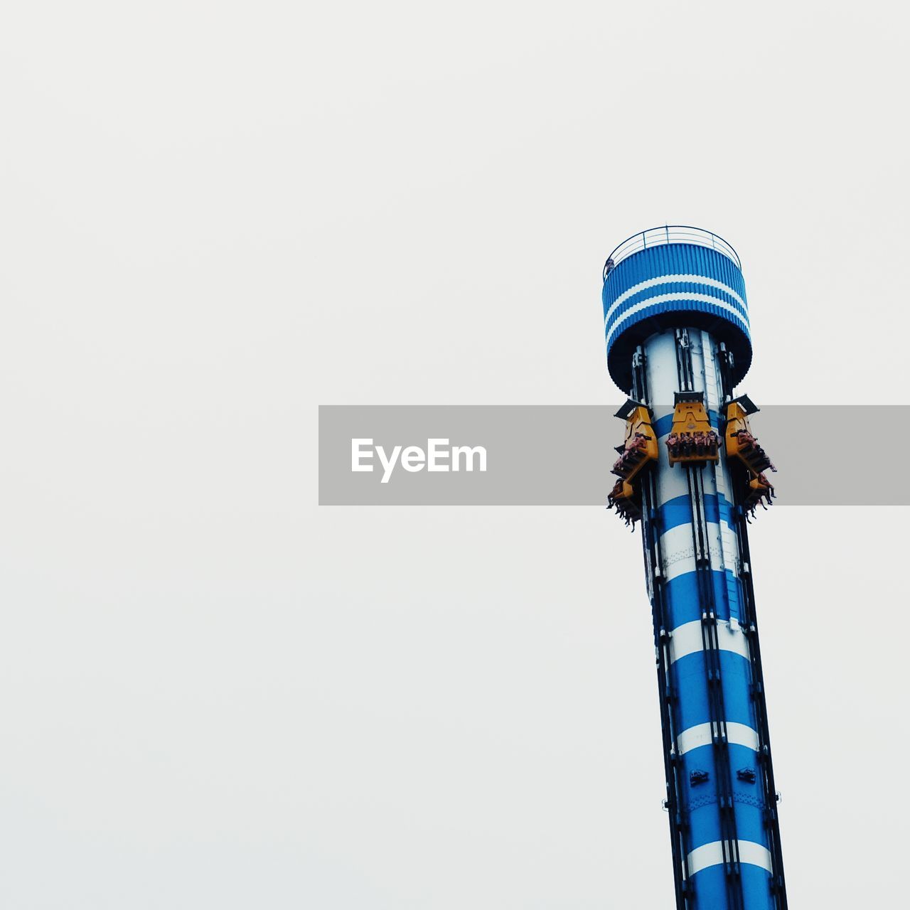 Low angle view of amusement park ride against clear sky