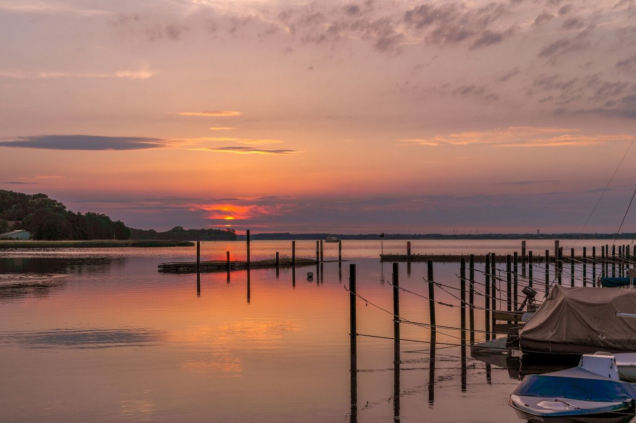 REFLECTION OF CLOUDS IN SEA AT SUNSET