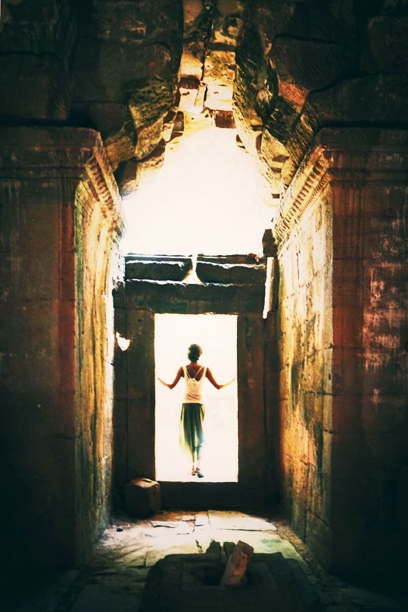 Rear view of woman at doorway in angkor wat