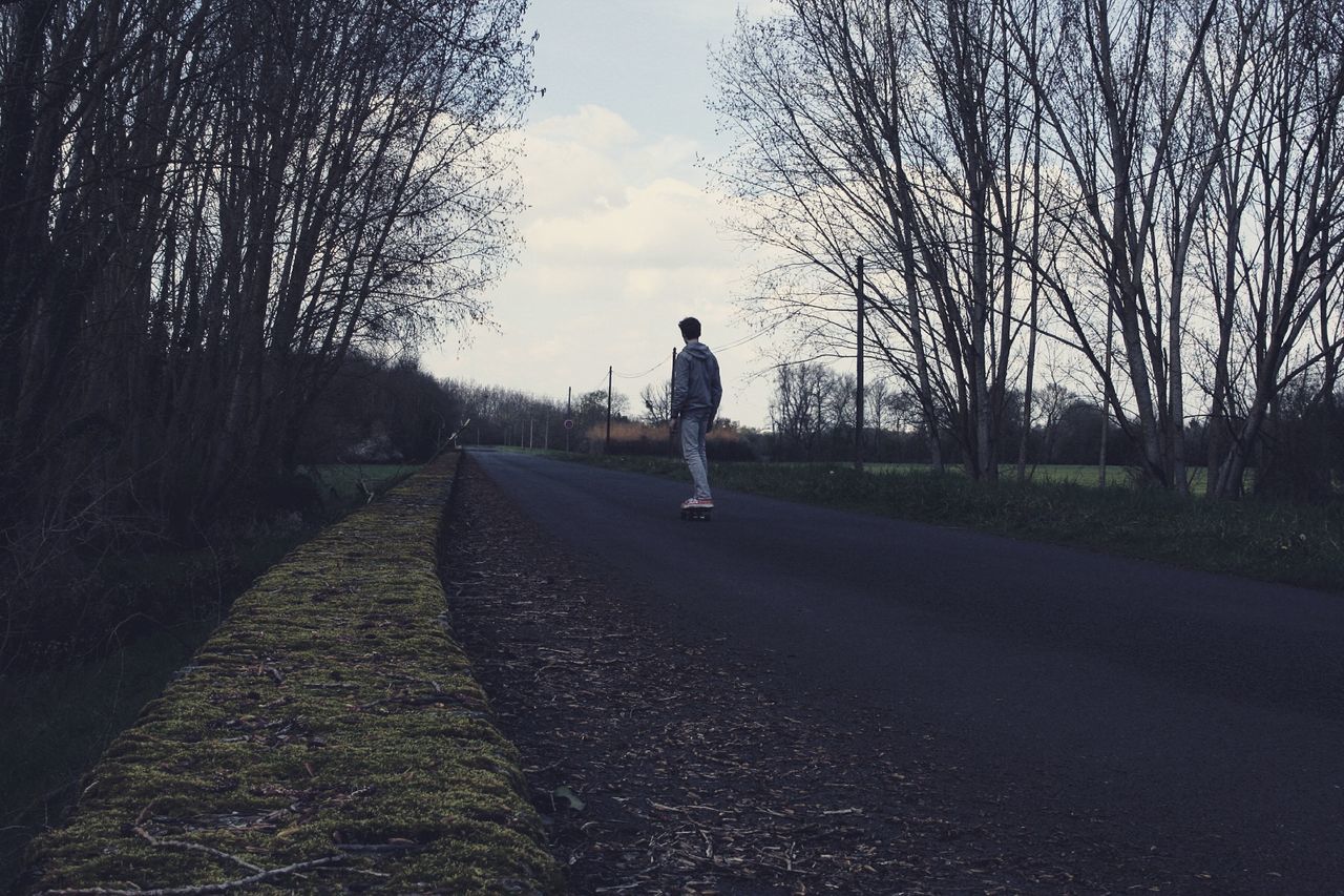 WOMAN WALKING ON ROAD