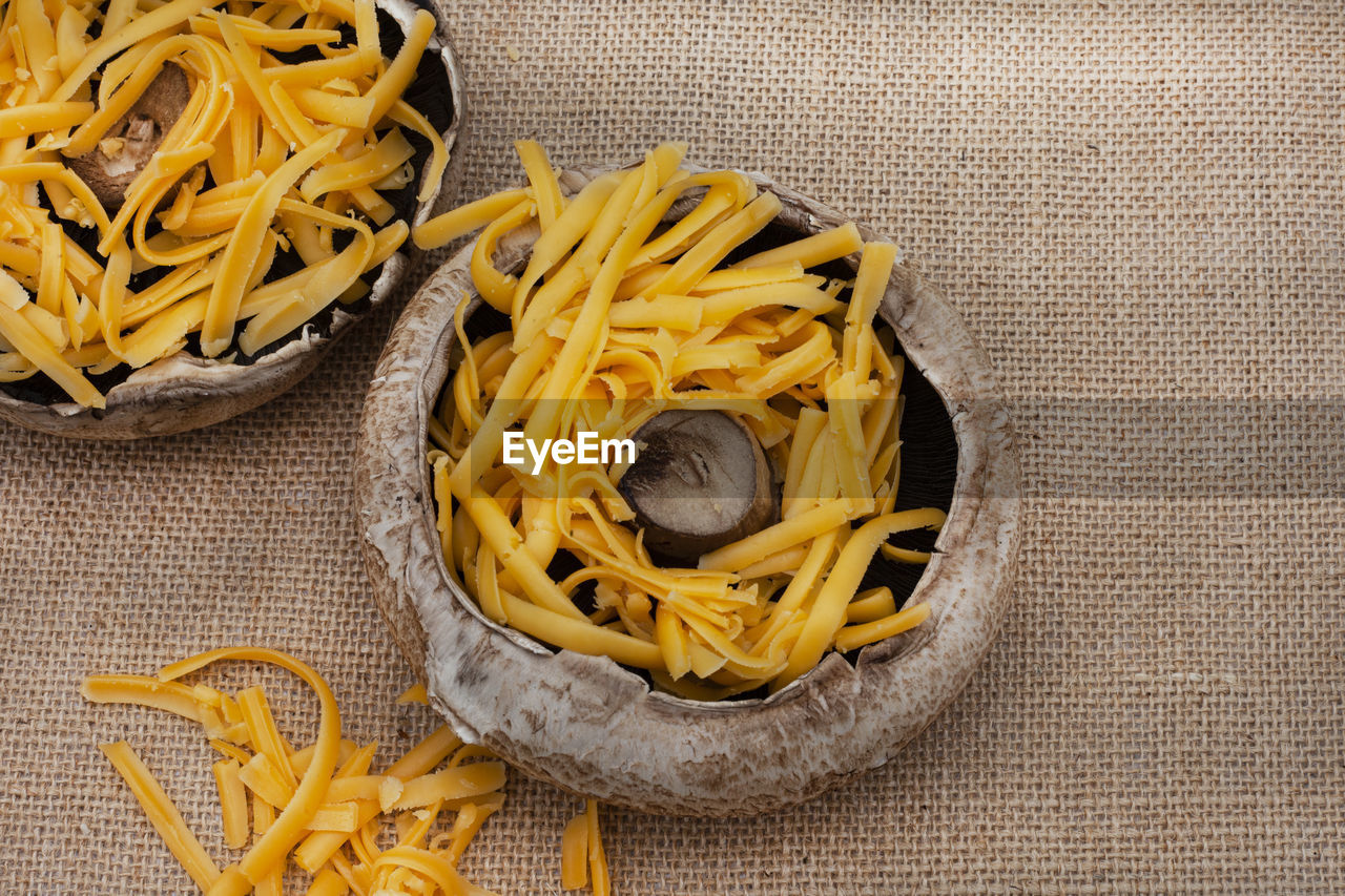 pasta, italian food, yellow, food, food and drink, freshness, high angle view, still life, no people, indoors, cuisine, produce, dish, directly above, spaghetti, tagliatelle, wellbeing, healthy eating, close-up, raw food, table, flower