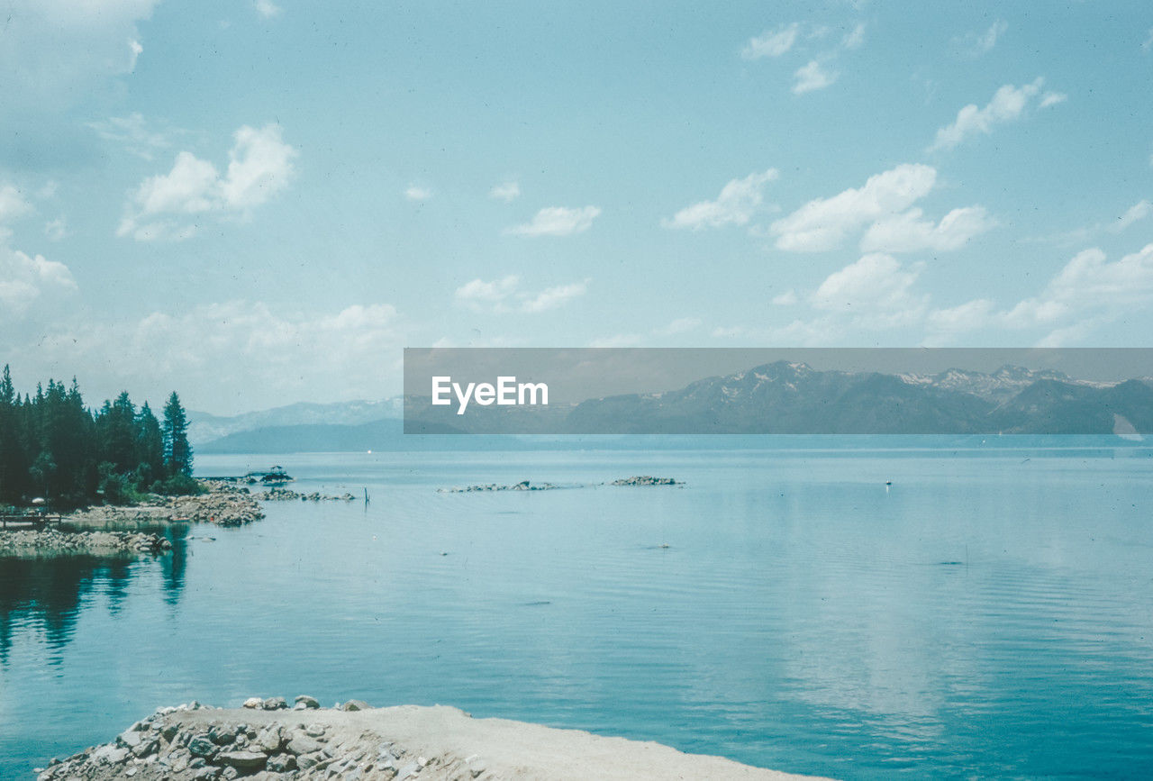 scenic view of lake against cloudy sky