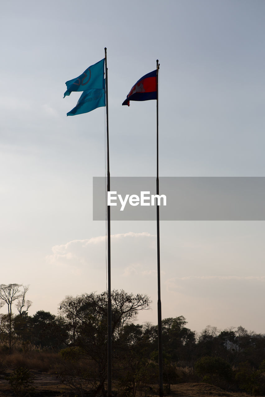 LOW ANGLE VIEW OF FLAGS AGAINST SKY