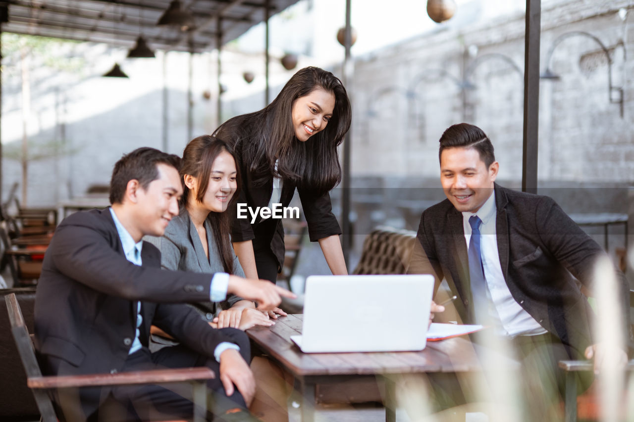 business colleagues working at desk in office