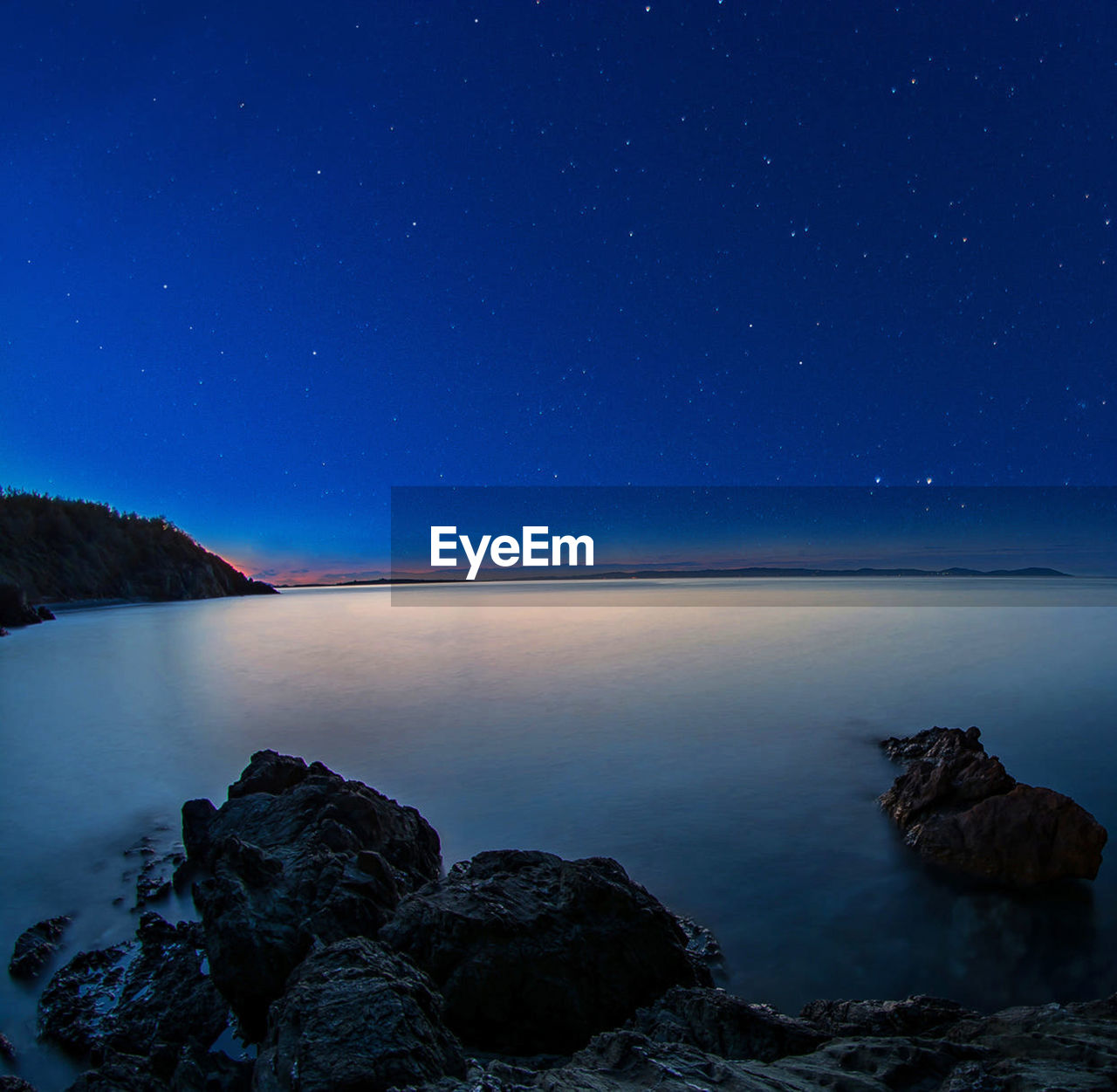 Scenic view of sea against sky at night