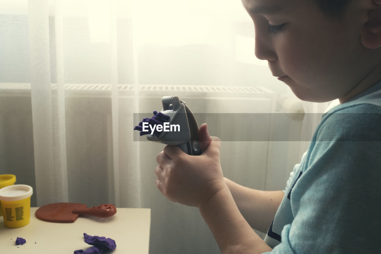 Boy playing with toy at home