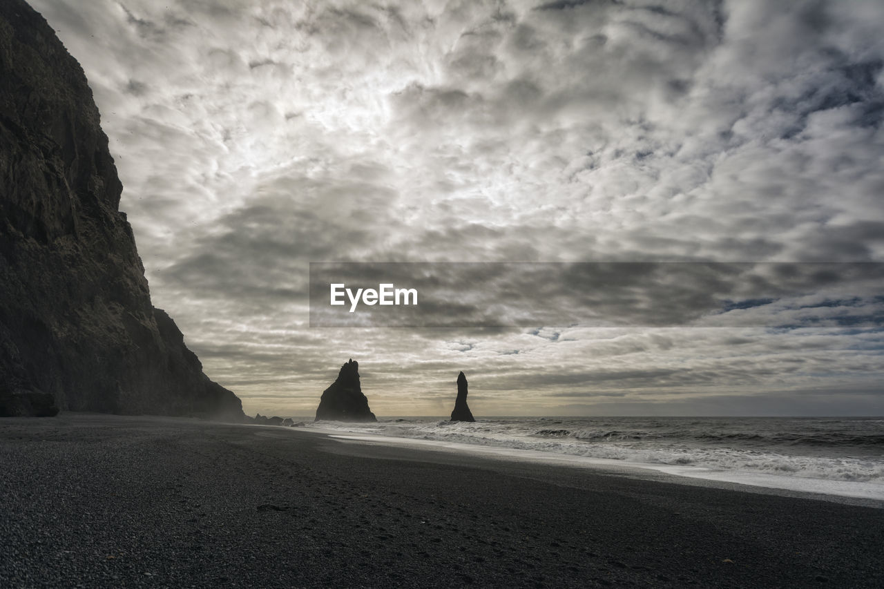 Scenic view of sea against cloudy sky