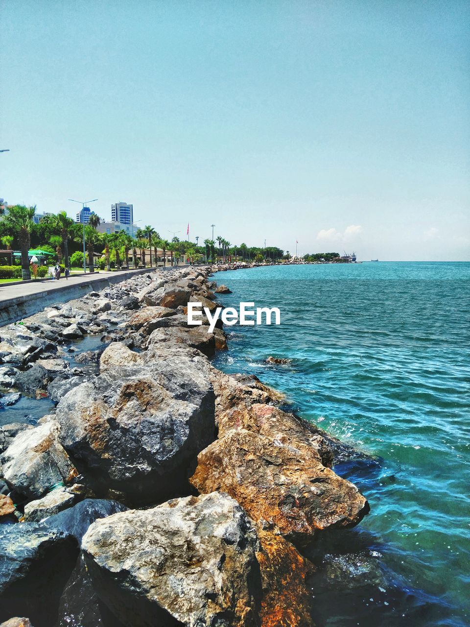 Scenic view of sea against blue sky during sunny day