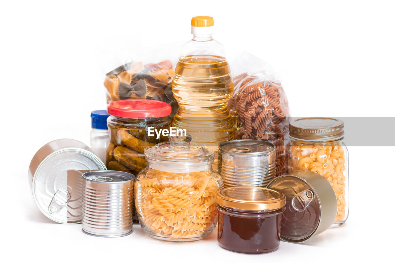 white background, container, jar, coin, bottle, studio shot, food, cut out, large group of objects, finance, glass, food and drink, no people, business, produce, savings, wealth, indoors