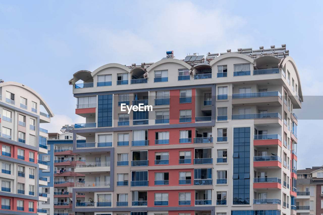 Colorful residential complex of several houses against the sky.