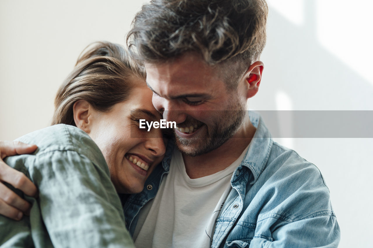 Man embracing woman at home