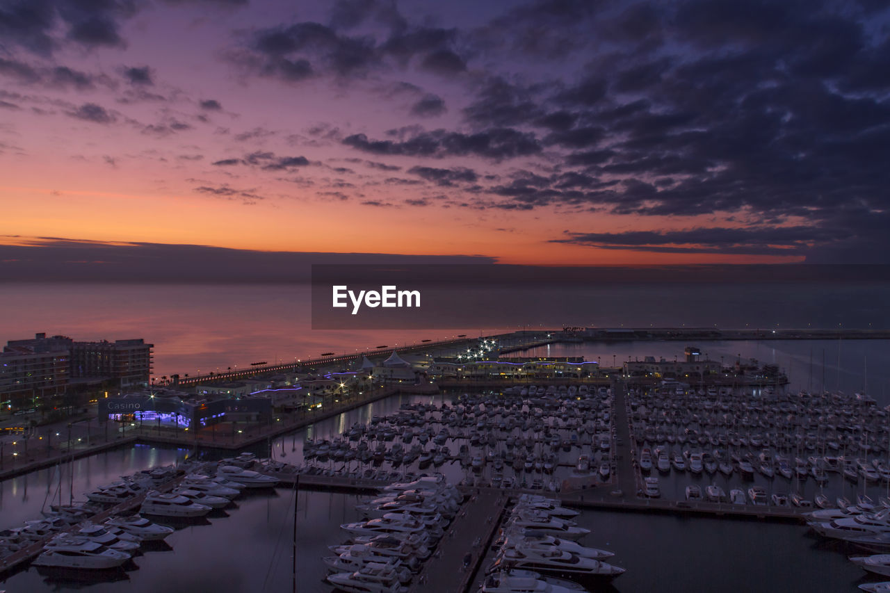High angle view of alicante by sea against sky during sunset