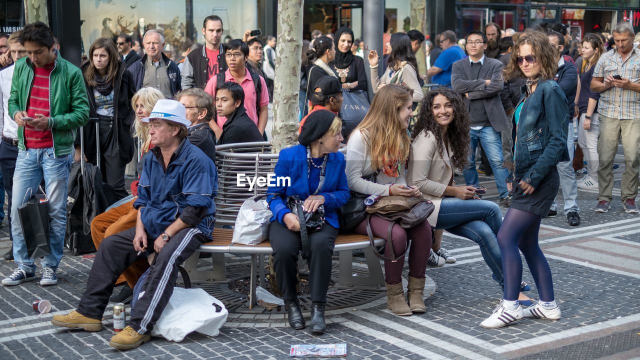 GROUP OF PEOPLE SITTING IN A ROW