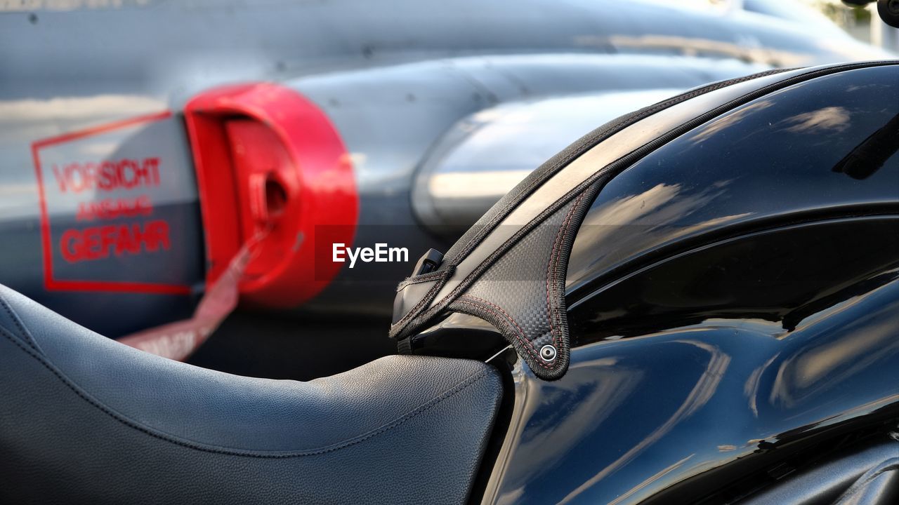 CLOSE-UP OF RED CAR ON MIRROR