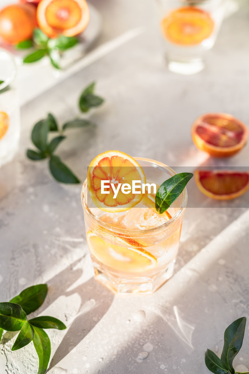 Tonic nonalcoholic mocktail with sicilian oranges and ice. cold refreshing summer mojito lemonade.