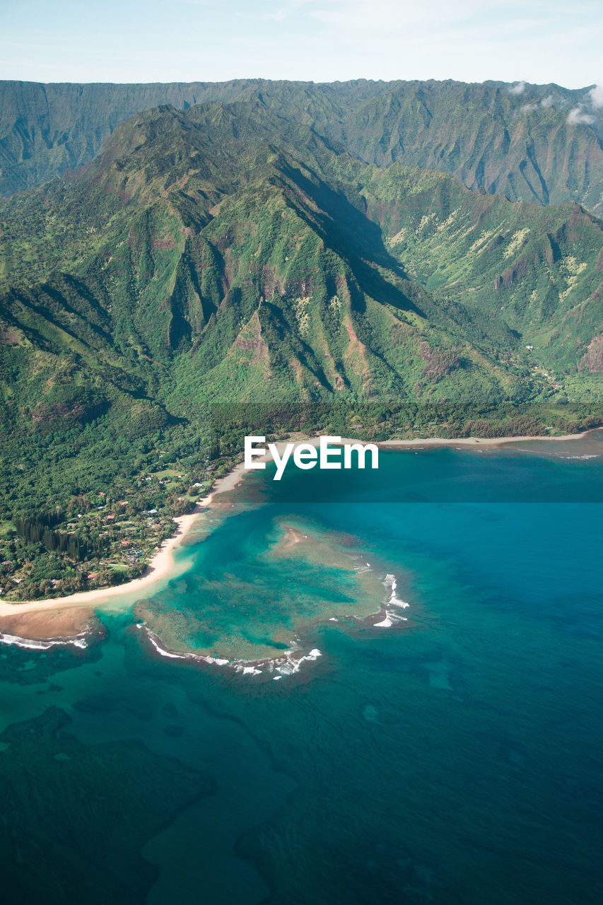 Scenic view of rock mountains by sea