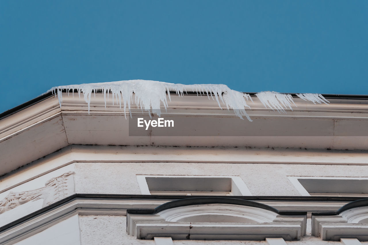 Icicles hanging from the edge of roof